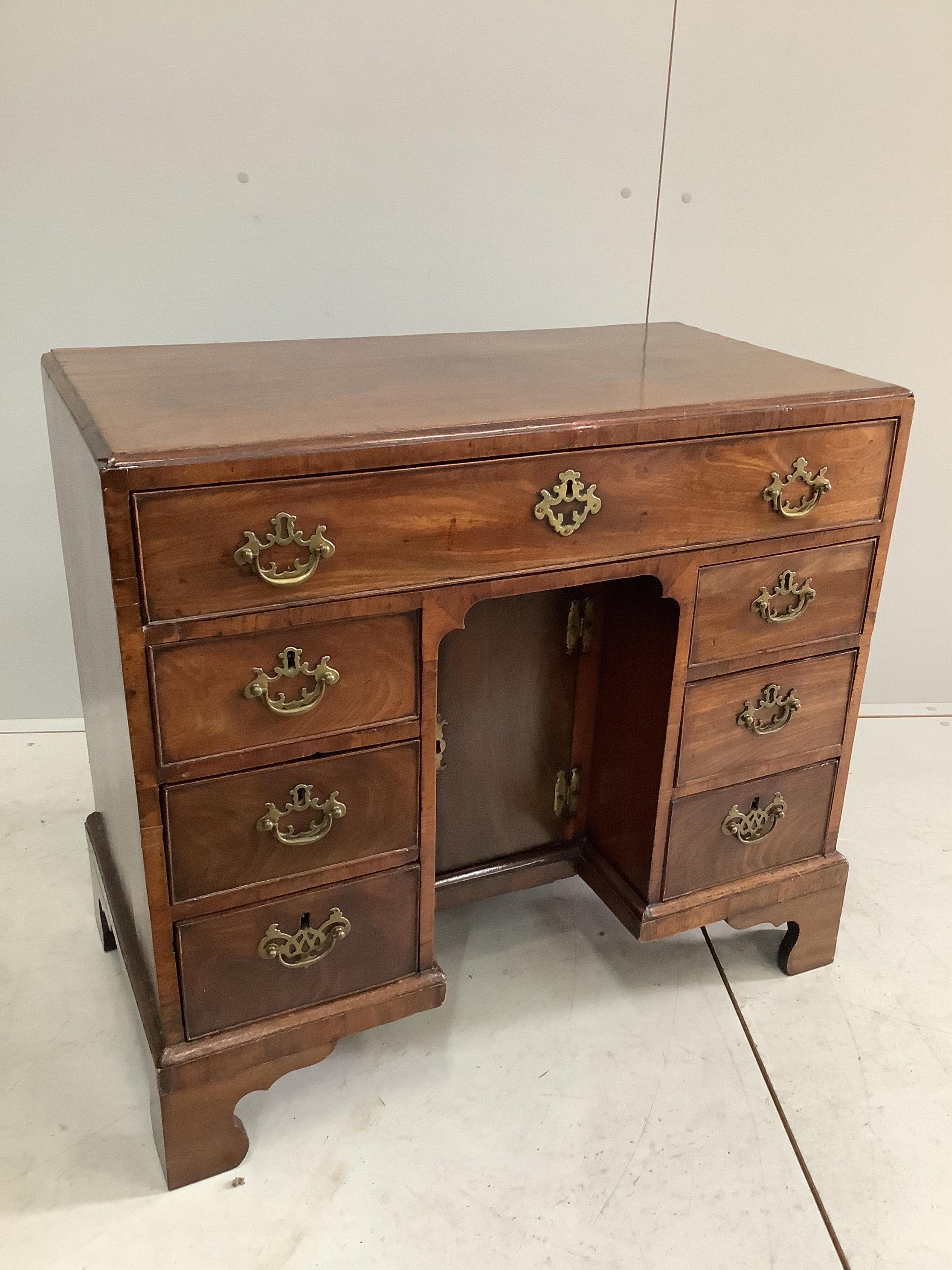 A George III mahogany kneehole desk, width 83cm, depth 44cm, height 76cm. Condition - fair